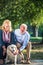 Happy Senior couple outdoors with dog enjoying