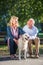 Happy Senior couple outdoors with dog enjoying