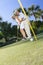 Happy Senior Couple Playing Golf Putting on Green