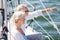 Happy senior couple on sail boat or yacht in sea