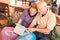 Happy senior couple sitting with digital laptop during at travel trip