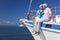 Happy Senior Couple Sitting on a Sail Boat