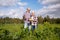 Happy senior couple on squash garden bed at farm