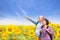 Happy senior couple standing in the sunflower garden