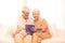 Happy senior couple with tablet pc at home