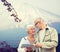 Happy senior couple with travel map over mountains