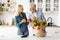 Happy Senior Couple Unpacking Paper Bag With Fresh Vegetables After Grocery Shopping