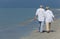 Happy Senior Couple Walking Holding Hands Tropical Beach