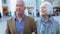 Happy Senior Couple Walking Through Outdoor Shopping Area