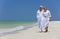 Happy Senior Couple Walking on A Tropical Beach