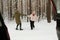 Happy senior couple in winterwear having fun and dancing in winter forest