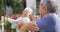 Happy senior diverse couple practicing yoga in garden