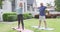 Happy senior diverse couple practicing yoga in garden