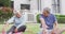 Happy senior diverse couple practicing yoga in garden