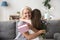 Happy senior grandma hugging granddaughter thanking for gift and