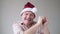 Happy senior hispanic man in christmas red hat dancing being happy that it is holidays.