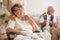 Happy senior lady sitting at wheelchair in nursing home for elderly