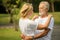 Happy senior loving couple relaxing at park embracing together in morning time. old people  hugging and enjoying spending time .