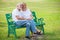 Happy senior loving couple relaxing at park embracing together in morning time. old people sitting on a bench in the autumn park