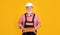 happy senior man bricklayer in hard hat on yellow background