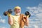 Happy senior man with dumbbell looking at camera. Grandfather exercising with dumbbell. Sport for senior man.