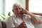 Happy senior man laugh talking on cellphone at home