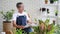 Happy senior man reading newspaper in the garden room. People and Lifestyle concept