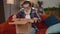 Happy senior man shopper unpacking cardboard box delivery parcel online shopping purchase at home