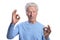 Happy senior man showing ok signs on white background