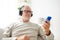 Happy senior man with smartphone and headphones