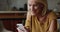 Happy senior mature smartphone user lady enjoying online chat