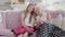 Happy senior mother and adult daughter sitting on couch talking and smiling at camera. Portrait of beautiful relaxed