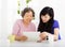 Happy senior Mother and daughter learning tablet pc