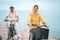 Happy senior muslim couple exercising riding bicycle together