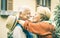 Happy senior retired couple having fun kissing outdoors at travel time