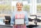 happy senior woman in apron with tablet pc at home