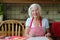 Happy senior woman baking cookies in the kitchen