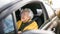 Happy senior woman driving car alone, enjoying car ride. Safe driving for elderly adults, older driver safety.