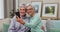 Happy senior woman, friends and selfie for photograph, memory or picture together on living room sofa at home. Elderly