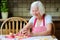 Happy senior woman making cookies at the kitchen