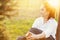 Happy senior woman relaxing on green lawn. Close up face of a mature brunette woman smiling relaxing. Retired woman in casuals