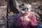 Happy senior years old mature retired beautiful lady with white hair enjoying the outdoor leisure activity lifestyle and drink