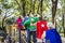 Happy seniors wearing superhero costumes at a playground