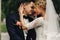 Happy sensual handsome groom and blonde beautiful bride in white