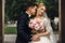 Happy sensual handsome groom and blonde beautiful bride in white