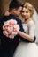 Happy sensual handsome groom and blonde beautiful bride in white
