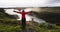 Happy serene adventure woman enjoying fresh air and amazing nature landscape with arms out at beautiful Gullfoss