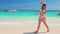 Happy sexy woman in bikini enjoying tropical sea and exotic beach in Punta Cana, Dominican Republic