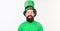 Happy shamrock day. Bearded man celebrating saint patricks day. Irish man with beard wearing green. Hipster in