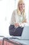 Happy shes working here. Portrait of a smiling business woman who is sitting on her desk in front of her laptop.